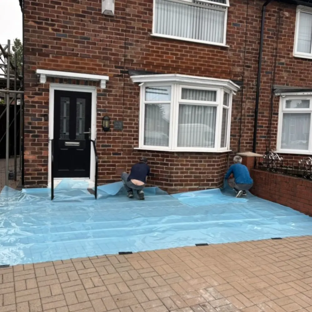 Plasterers installing corner beads for crisp lines on an external rendering job