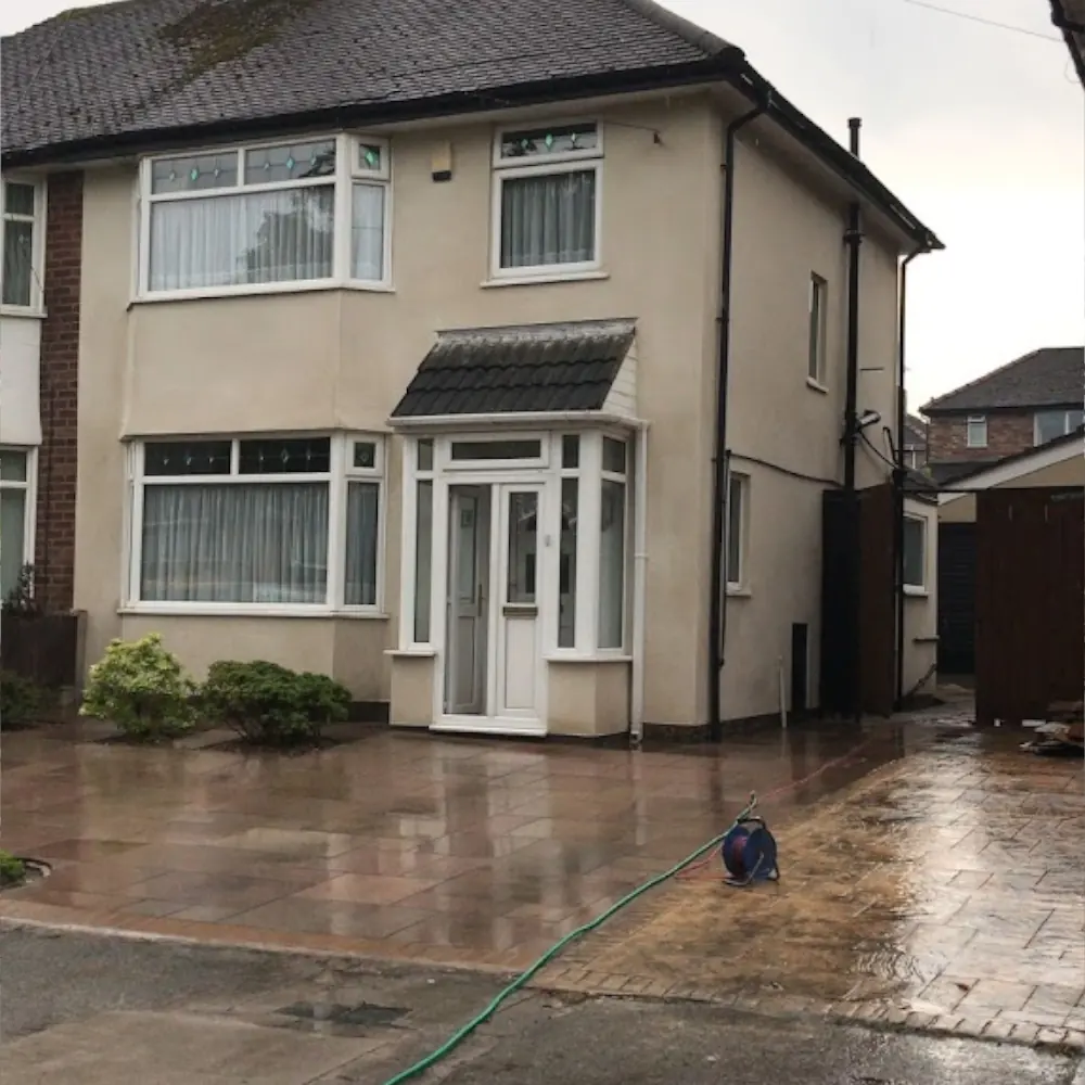 Applying a through-colour monocouche render to a front garden wall